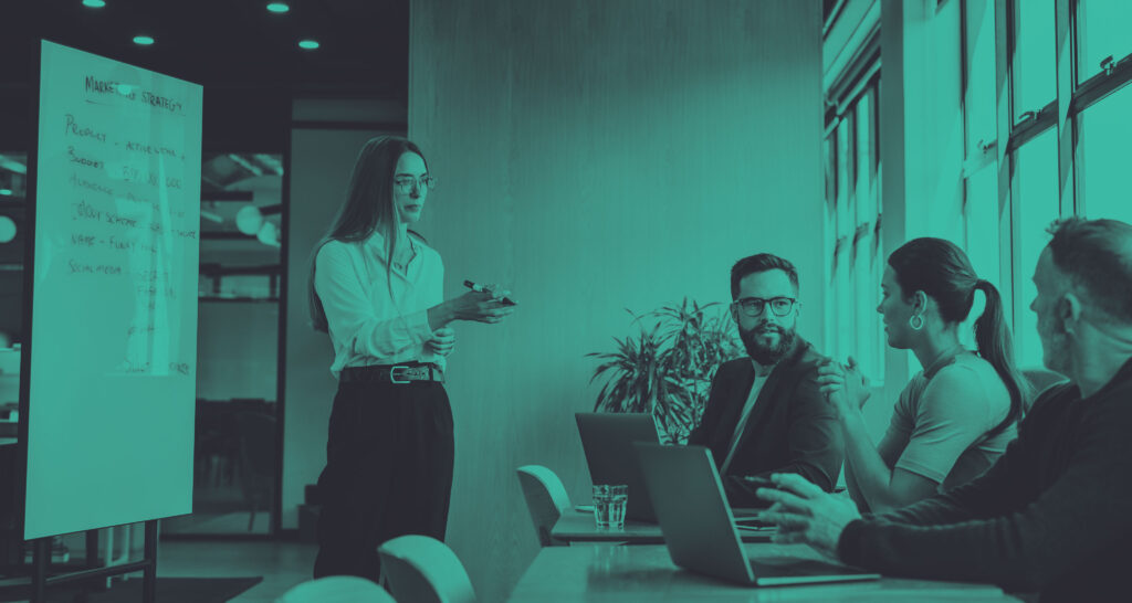 lady standing talking to her two male team members on strategy