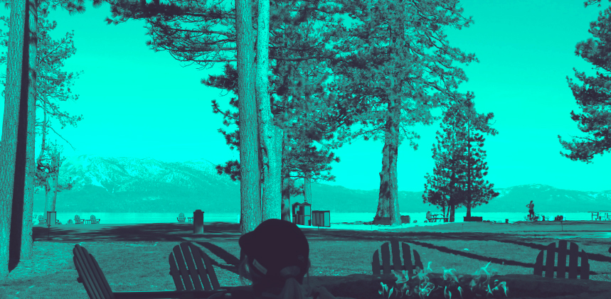 A serene lakeside view with towering pine trees and distant mountains, featuring Adirondack chairs in the foreground and a person enjoying the scene, all cast in a cyan tint.