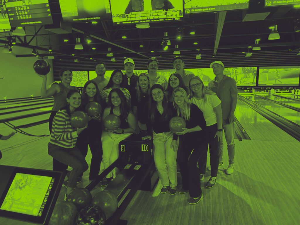 team photo of digital edge members at a bowling alley