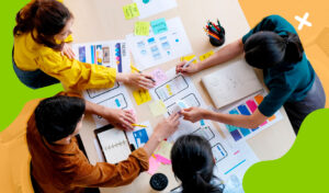 arial view of people at a desk using paper mockups for user experience design