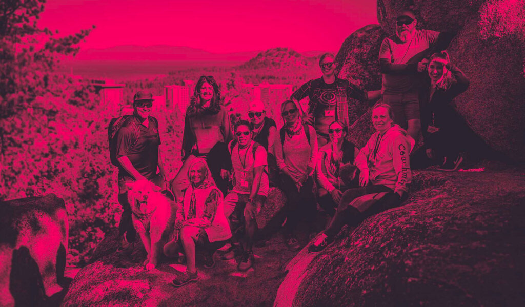 lake tahoe FAM trip witha. group of meeting planners on a hike at the peak of a mountain