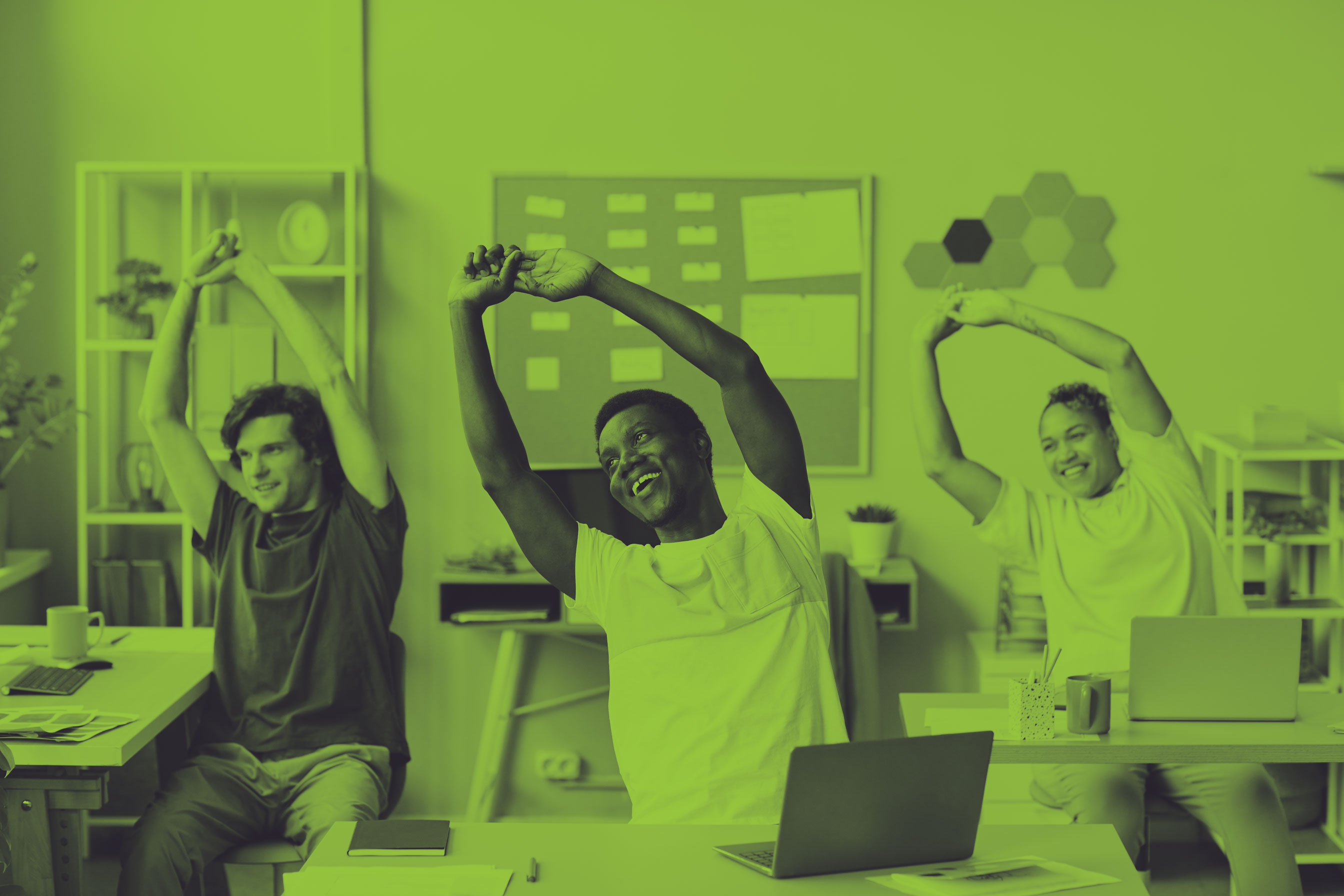 a diverse group of 3 employees stretching at their office desks